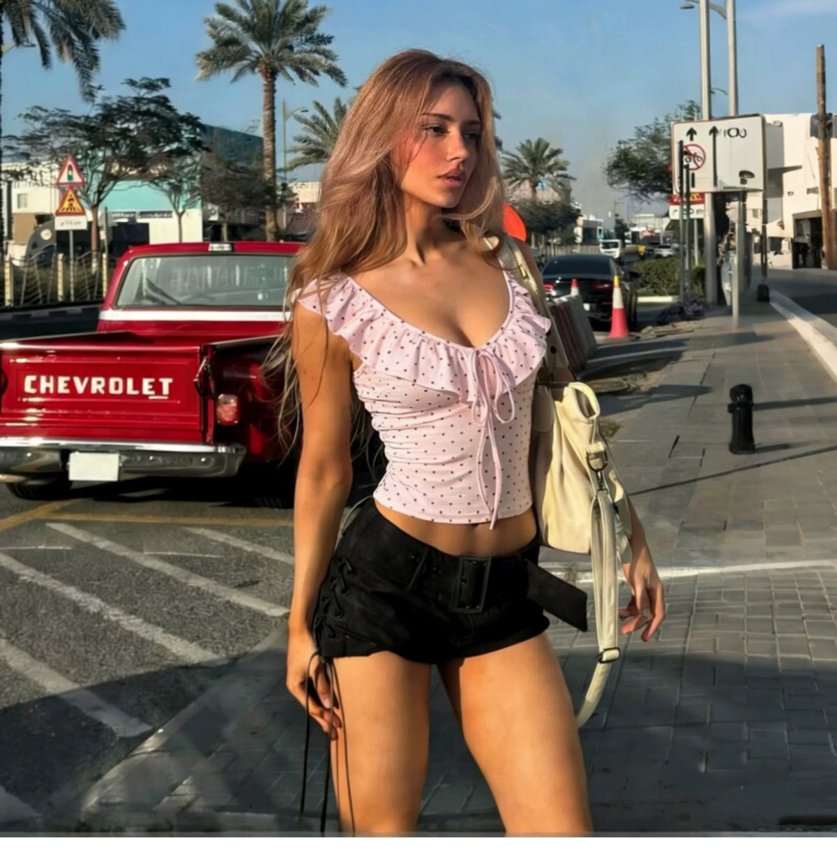 Dot pattern ruffled low round-neck halter top with straps, revealing the back, elastic-waisted, form-fitting short blouse for women